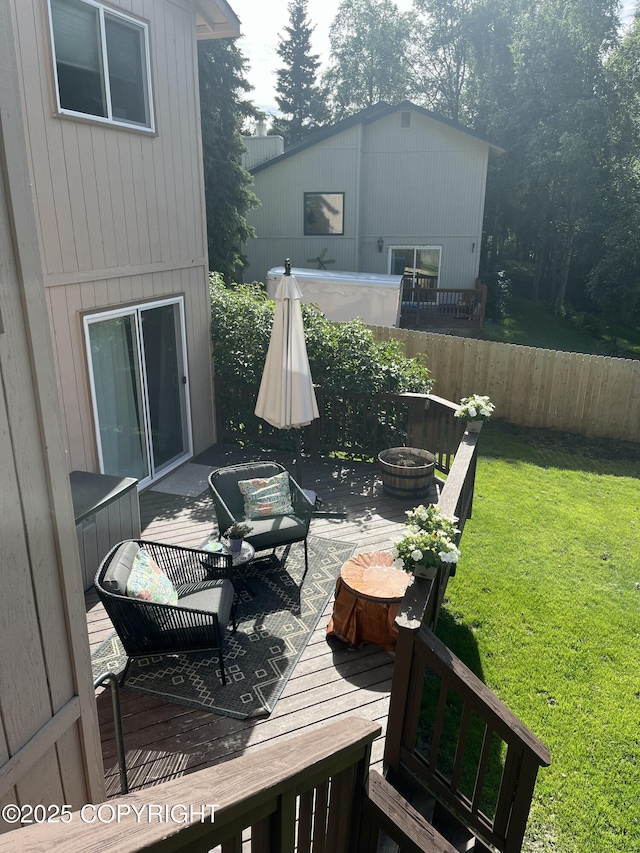 deck with a lawn, an outdoor hangout area, and fence