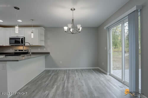 kitchen featuring baseboards, light wood-style floors, appliances with stainless steel finishes, and white cabinetry