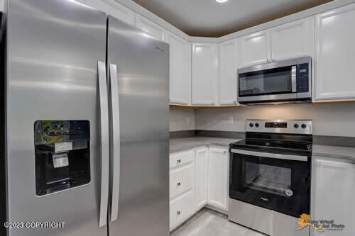 kitchen featuring light countertops, white cabinets, and stainless steel appliances