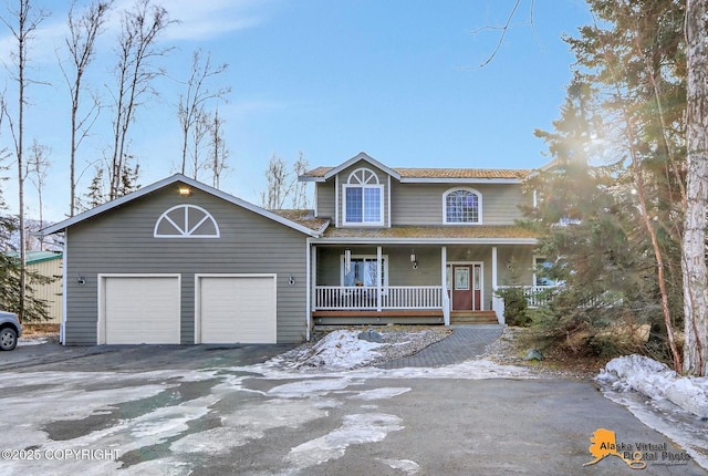 view of front of house with aphalt driveway, a porch, and a garage