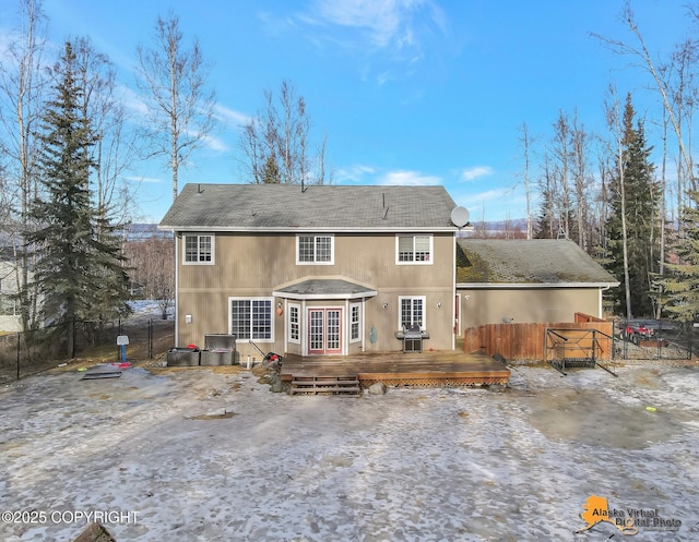 rear view of house featuring a deck, french doors, and fence