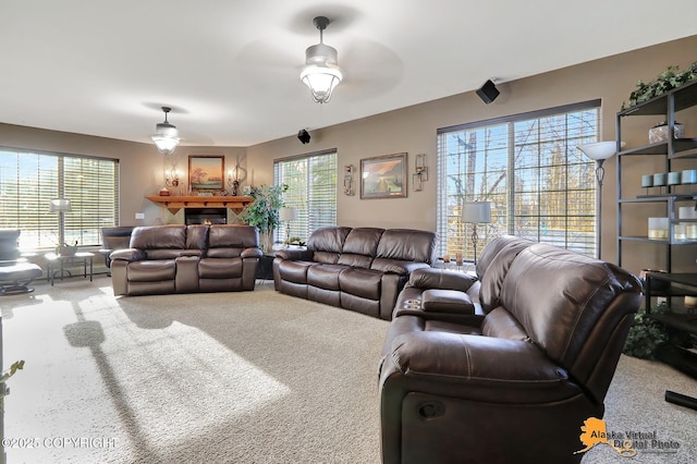 living room with carpet flooring and a ceiling fan