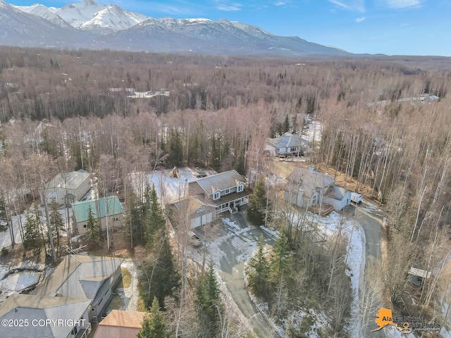 drone / aerial view with a forest view and a mountain view