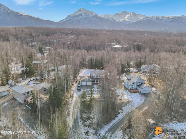 aerial view featuring a forest view and a mountain view