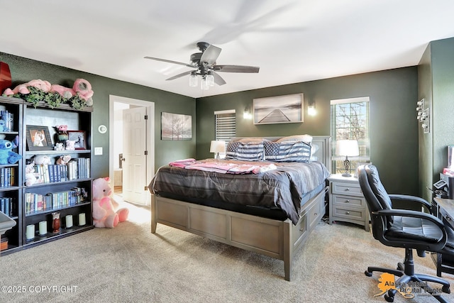 bedroom with a ceiling fan and light colored carpet