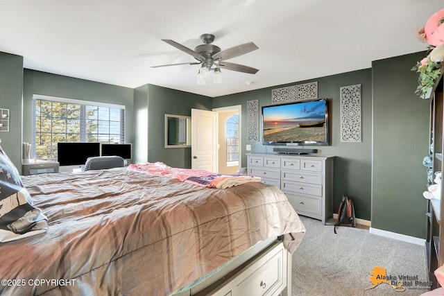 bedroom featuring ceiling fan, baseboards, and light carpet