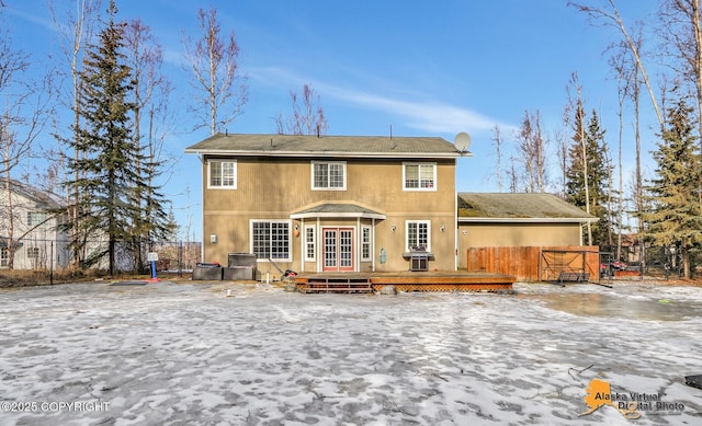 rear view of house with a deck and fence