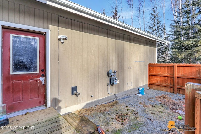 view of exterior entry with fence