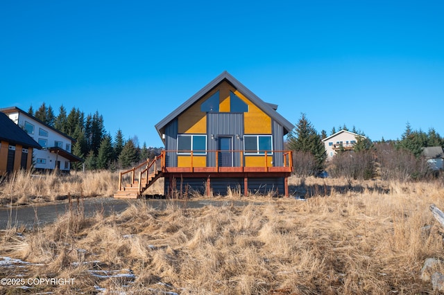 rear view of house with stairs and a deck