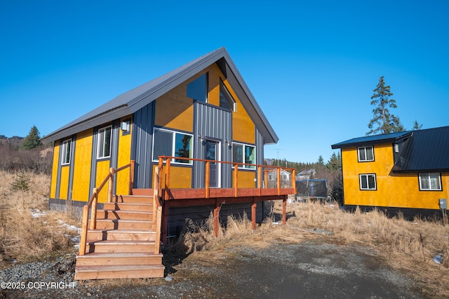 view of front facade featuring a trampoline and a wooden deck