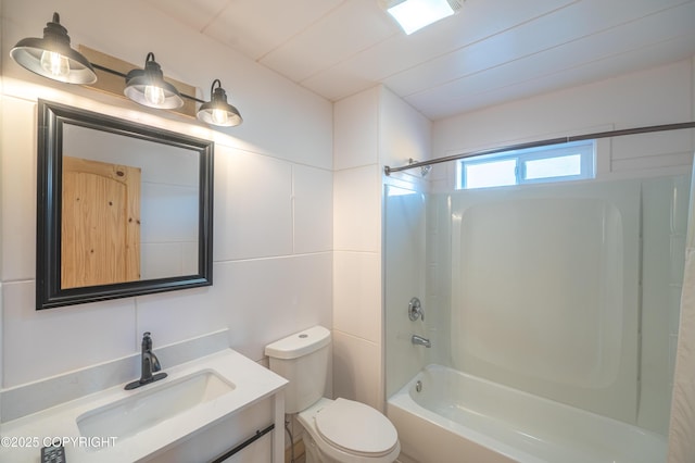 bathroom with vanity, toilet, and shower / bath combination