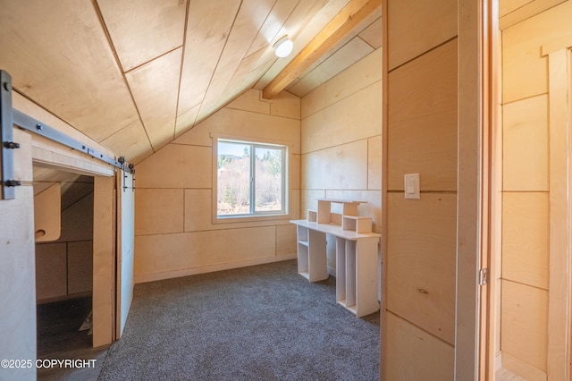 additional living space featuring vaulted ceiling with beams and carpet