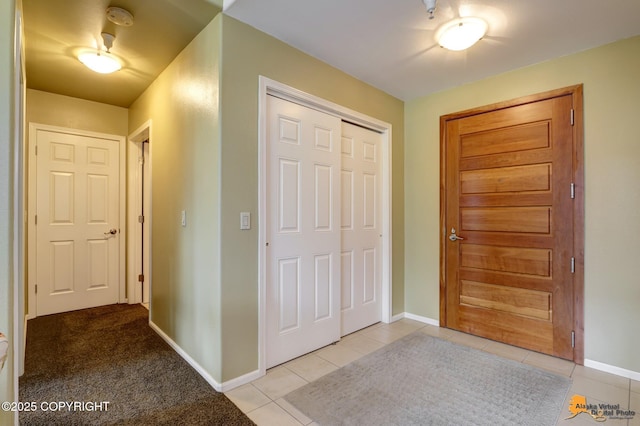 entrance foyer with light tile patterned flooring and baseboards