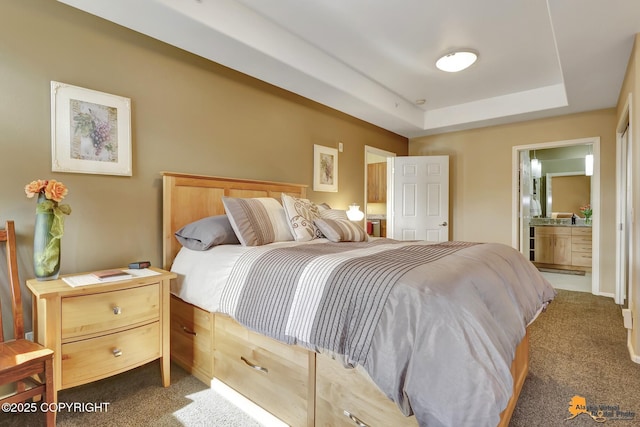 bedroom featuring carpet flooring, connected bathroom, and a raised ceiling