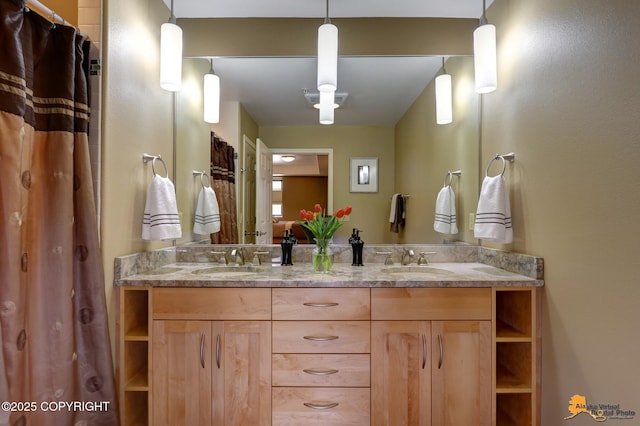 full bathroom with double vanity and a sink