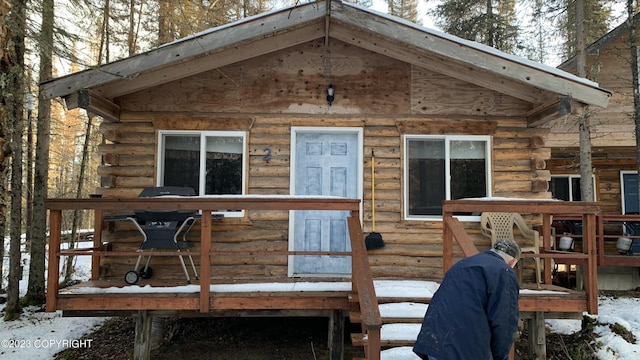 exterior space featuring log siding and a deck