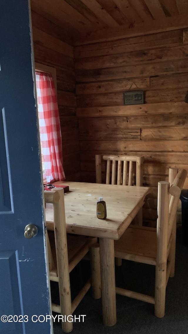 unfurnished dining area featuring wooden walls, a sauna, and wood ceiling