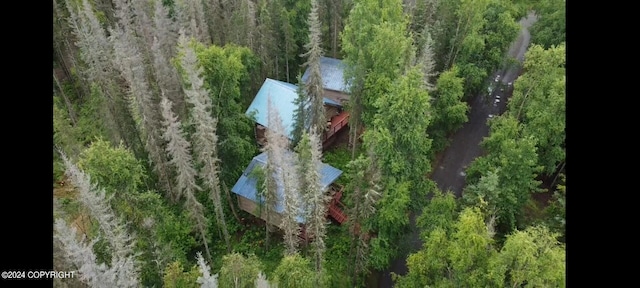 birds eye view of property with a wooded view