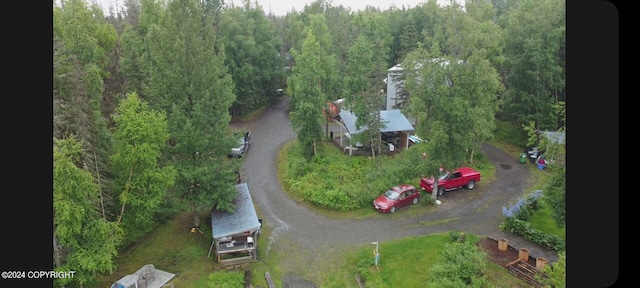 birds eye view of property with a view of trees