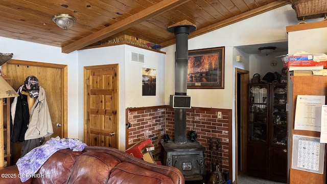 living room with visible vents, wooden ceiling, lofted ceiling with beams, and a wood stove