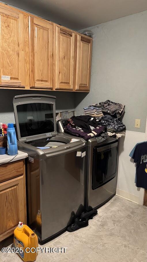 laundry room with cabinet space and washer and dryer