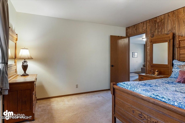 bedroom featuring baseboards and light carpet