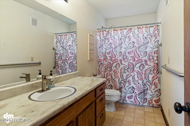 full bath featuring vanity, toilet, visible vents, and tile patterned flooring