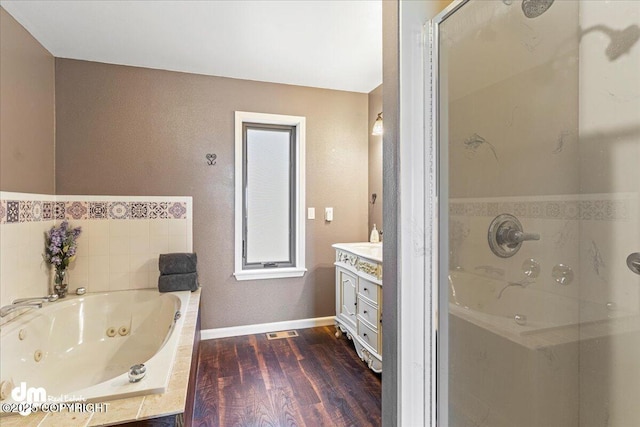 bathroom featuring visible vents, a stall shower, wood finished floors, a tub with jets, and vanity