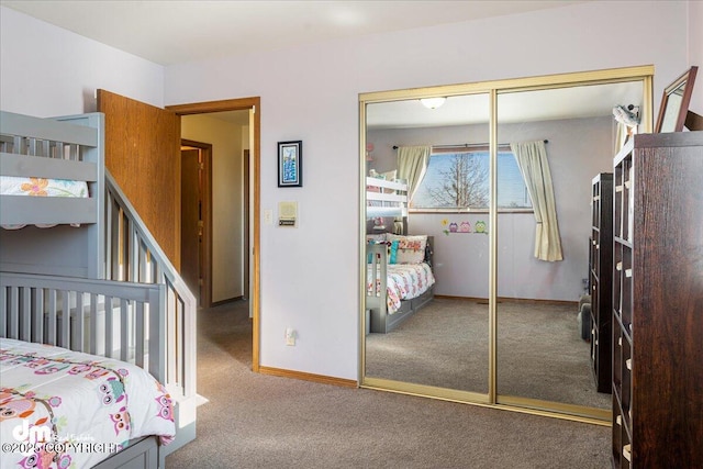 carpeted bedroom with baseboards and a closet