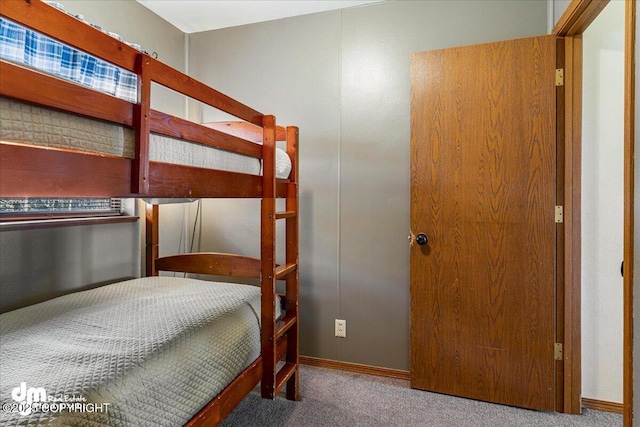 bedroom featuring baseboards and carpet