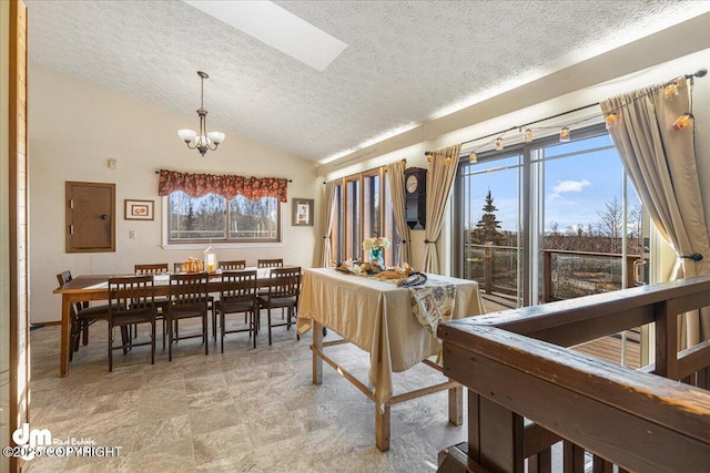 dining room featuring a textured ceiling, a notable chandelier, and vaulted ceiling