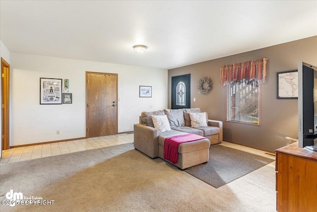 living area featuring light colored carpet and baseboards