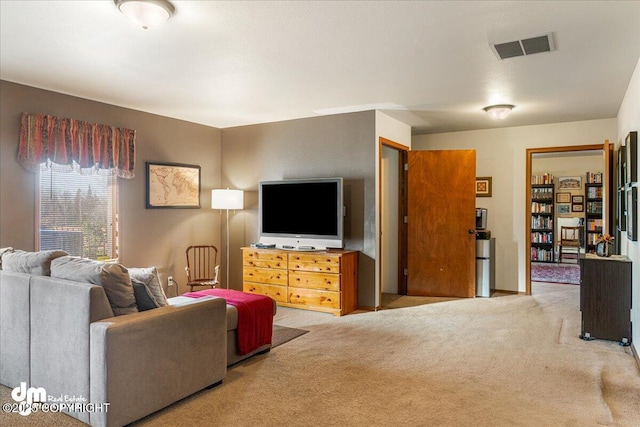 living room with visible vents and carpet flooring