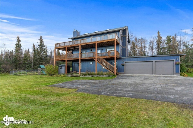 exterior space with an outbuilding, stairway, a wooden deck, aphalt driveway, and a lawn