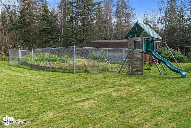 communal playground with a yard and fence