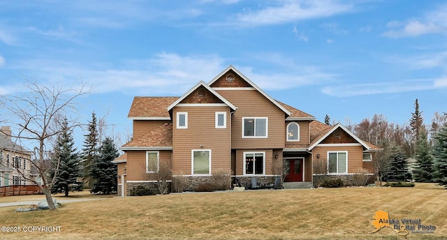 craftsman house featuring a front yard and stone siding