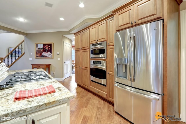 kitchen with visible vents, crown molding, light stone countertops, light wood-style floors, and stainless steel appliances