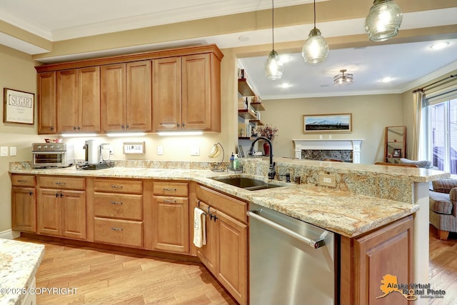 kitchen featuring light wood finished floors, a peninsula, ornamental molding, a sink, and stainless steel dishwasher