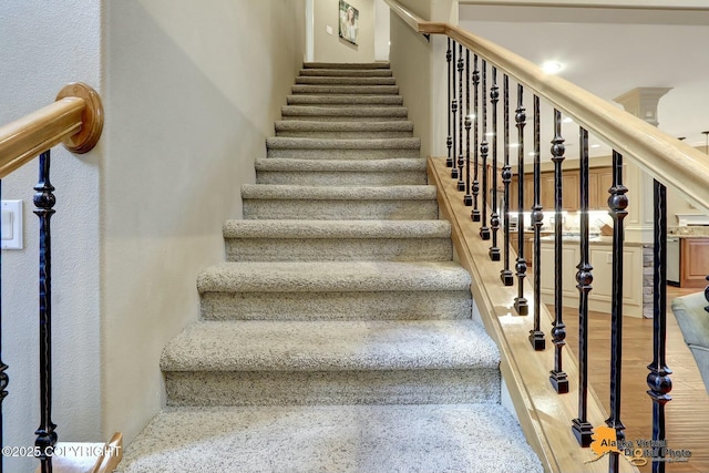 staircase with wood finished floors