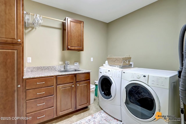 clothes washing area featuring cabinet space, light tile patterned flooring, washing machine and dryer, and a sink