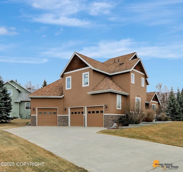 view of front of house with a garage, a front yard, concrete driveway, and stone siding