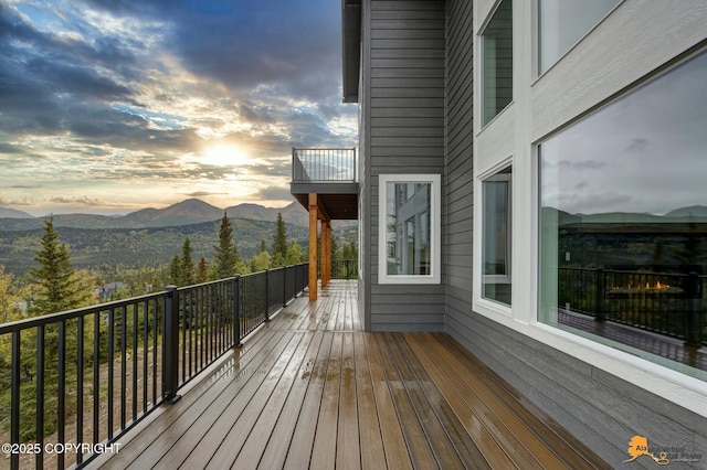 deck at dusk featuring a mountain view