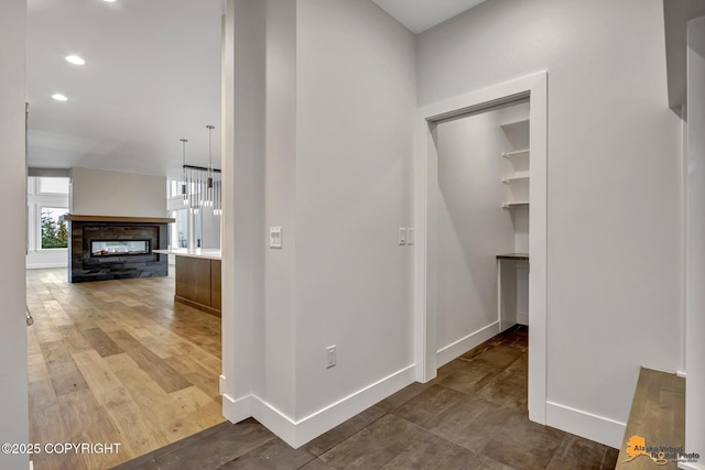 hallway with recessed lighting, baseboards, and wood finished floors