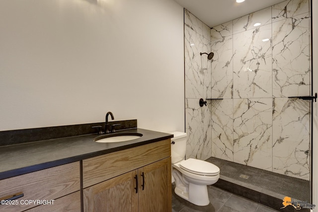 bathroom featuring a marble finish shower, toilet, and vanity