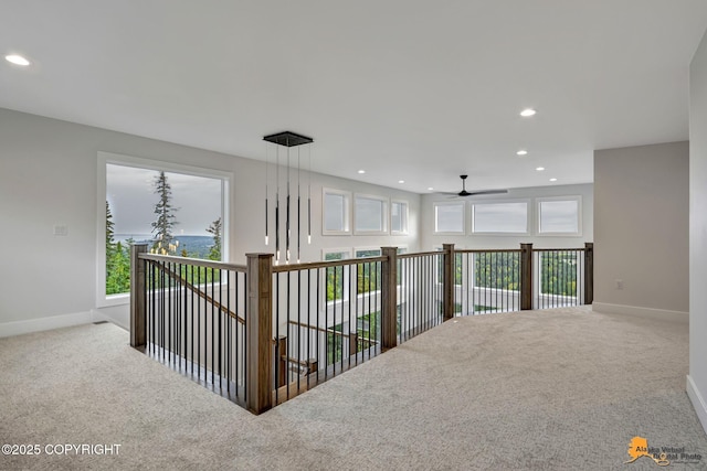 corridor featuring carpet flooring, recessed lighting, and baseboards