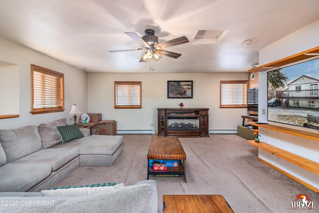 carpeted living room with a ceiling fan, a wealth of natural light, and a baseboard radiator