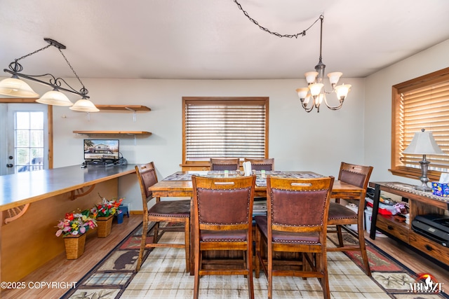 dining room featuring a chandelier and light wood-style flooring