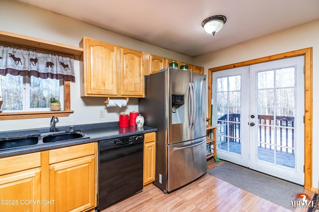 kitchen featuring a sink, french doors, stainless steel refrigerator with ice dispenser, dishwasher, and dark countertops