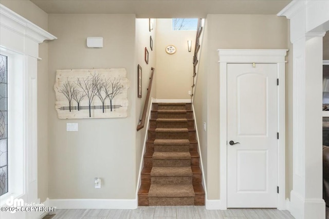 staircase featuring baseboards