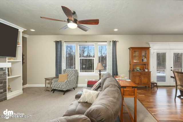 carpeted living room with baseboards, ceiling fan, recessed lighting, french doors, and a textured ceiling